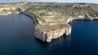 Aerial View of Dramatic Limestone Cliffs and Terraced Fields on the Coast of Malta, with Deep Blue Mediterranean Sea - Maltese Landscape