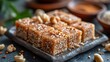 Sesame halva sprinkled with sesame seeds. Traditional oriental sweets. Concept of homemade confectionery, nutty fudge treats, artisanal dessert crafting, and sweet indulgence.