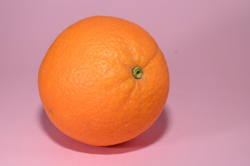 juicy orange on a pink background studio shooting 1