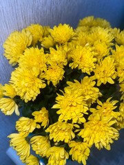 yellow small flowers in a vase on the table