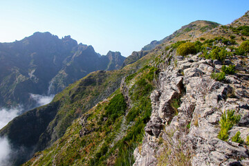 Wall Mural - Mountainous landscape near the Pico Ruivo, the highest mountain peak on Madeira island, Portugal - Heathland on dry slopes in the Atlantic Ocean