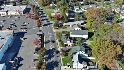 Wall Mural - Aerial view of road with cars in small American town