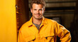 Portrait of a handsome young man in workwear standing in warehouse