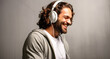 Portrait of a handsome young man listening to music with headphones.