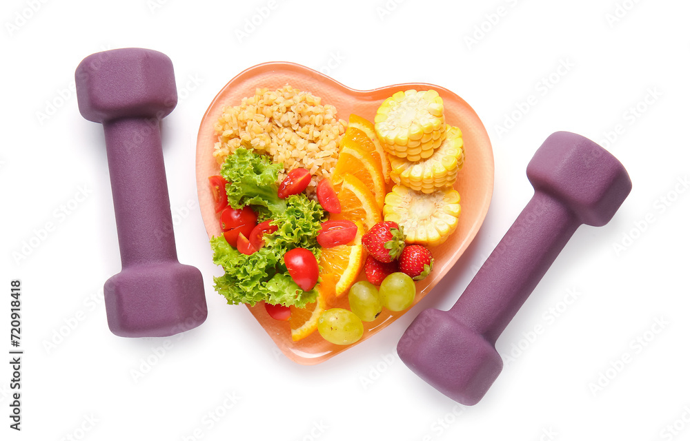 Plate with fresh healthy products and dumbbells on white background. Diet concept