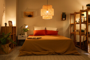 Poster - Interior of cozy bedroom with shelf units and glowing lamps at night