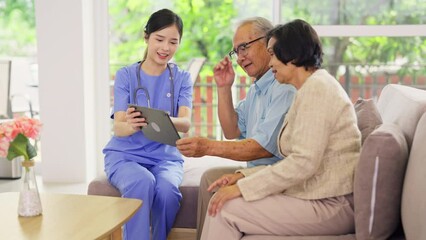 Wall Mural - Professional Asian nurse or doctor use tablet to consult and give assistant to couple senior man and woman in living room of clinic or hospital in senior healthcare center.