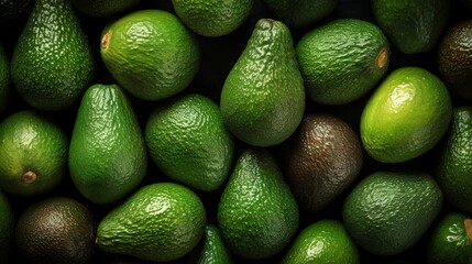 Top view of fresh green avocados for background.
