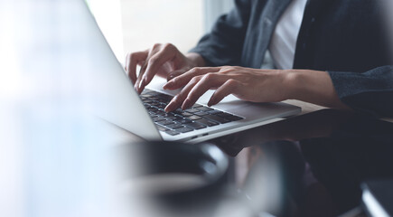 businesswoman hands typing on laptop computer keyboard, online working at modern workplace. woman su
