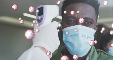 Poster - Image of covid-19 cells floating with man having temperature checked wearing face masks