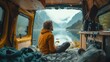 © Tirawat - Traveler enjoying serene lake view from cozy van interior; concept of wanderlust and vanlife