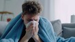 Sick person sit at home. Man under blue blanket sneezes into handkerchief tissue. Medical health care. Guy treats cold, illness, flu concept. Patient feel bad and rest in bedroom. Disease recovery.