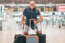 Happy Senior Bald Male Traveler Smiling Looking At Camera Leaving For A Trip From The Airport With Luggages Enjoys Holiday Vacation Leisure Activity