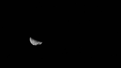 Wall Mural - Fast motion of crescent moon with craters moving among mysterious clouds at night. Telephoto view, real midnight footage with black background and copy space. Creepy halloween sky, astrology concept.
