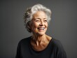 © shrinay - Portrait of smiling senior woman capture in the studio. Generative AI