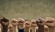© Arsen H - Many fists of multi-ethnic people raised upwards. A sign of unity and equality.