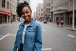 © PNG&Background Image - Young hipster black woman in a stylish denim jacket walking in the street, smiling and looking at the camera.
