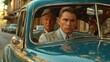 two men in a blue car sitting behind the wheel