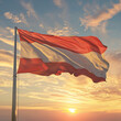 The flag of Austria waiving during sunrise. 