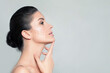 Face lift and Anti Aging Treatment. Beautiful Face of Spa Woman with White Lifting Arrows. Youth and skin care concept