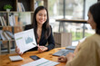 © Wasana - Two asian businesswoman accountants discuss financial management planning. Analysis of new startup project ideas