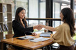 © Wasana - Businesswoman shaking hands during a meeting success, dealing, greeting and partner concept.