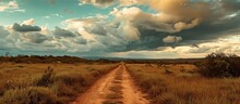 Dusty Path Surrounded By Vegetation, Under A Cloudy Sky In Wide Open Space.