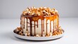 Caramel drip cake adorned with popcorn and pretzels on a light grey table – delicious dessert styling, perfect for celebrations, copy space available