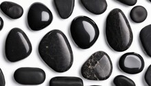 A Collection Of Black Rocks, Some With Reflective Surfaces, Are Arranged In A Visually Appealing Manner