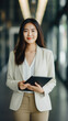 © Art AI Gallery - Portrait of young asian business woman using digital tablet in modern office