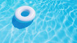 Inflatable ring floating in swimming pool with blue water background .