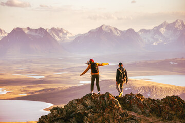 Aufkleber - Young couple of hikers with backpacks is walking at mountain top with great view
