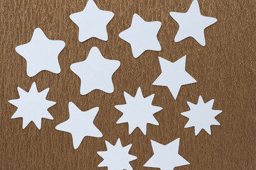 Poster - machine-cut white paper stars on golden metallic crepe paper