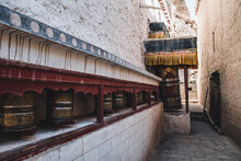Prayer Wheels At Tibetan Monastery Entrance