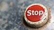Close-up of a red button with the word stop in it