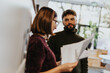 © qunica.com - Diverse business team collaborates and strategizes for growth through market analysis and project development.