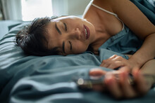 Young Woman Sleeping In Home Bed