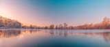 Fototapeta Natura - Calm lake water reflections forest trees panoramic sunrise sky. Beautiful silence morning dawn in early spring late winter. Soft bright pink purple colored sky panorama. Beautiful nature landscape
