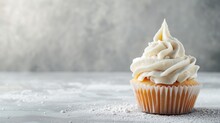 Single Vanilla Cupcake With Creamy White Icing And Sugar Dust