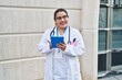 © Krakenimages.com - Young beautiful plus size woman doctor smiling confident using touchpad at hospital