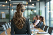 Female Business Leader Overseeing Team Meeting in Modern Office