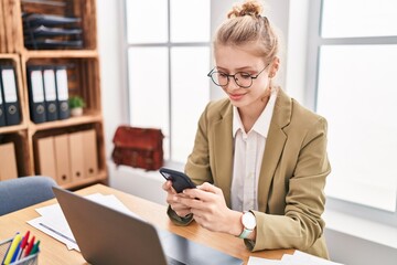 Wall Mural - Young blonde woman business worker using laptop and smartphone at office