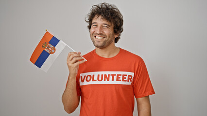 Wall Mural - Young hispanic man activist holding serbia flag over isolated white background