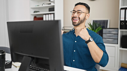 Poster - Young hispanic man business worker using computer celebrating at the office