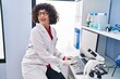 © Krakenimages.com - Young beautiful hispanic woman scientist smiling confident using computer at laboratory