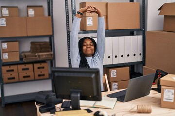 Wall Mural - African american woman ecommerce business worker using laptop stretching arms at street