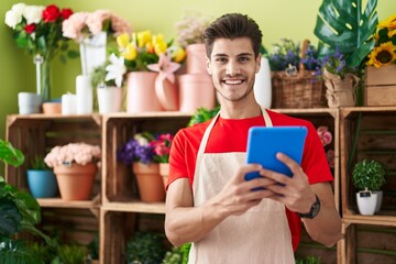 Sticker - Young hispanic man florist smiling confident using touchpad at flower shop