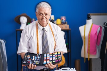 Canvas Print - Middle age grey-haired man tailor smiling confident holding sewing bag at tailor shop