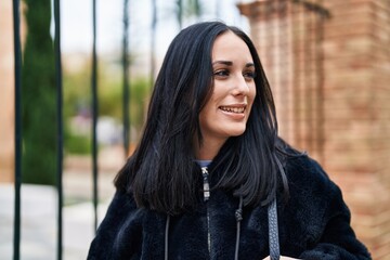 Sticker - Young caucasian woman smiling confident looking to the side at street