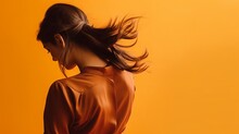 A Medium-sized Picture Of A Woman Bending Back With An Orange Background.